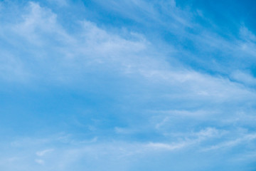 The blue sky with moving white clouds. The sky is a beautiful color shade suitable for use as a background image.