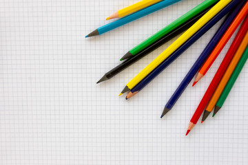 A blank sheet of paper in the box on it are colored pencils.