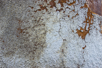 Rusty metal pipe with heat insulation residues in natural light