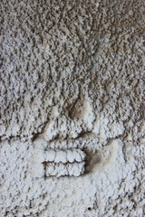 Rusty metal pipe with heat insulation residues in natural light