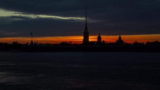 Time lapse of Peter and Paul fortress at sunset, darkness comes, boats and ferries pass along the Neva river, St. Petersburg, Russia