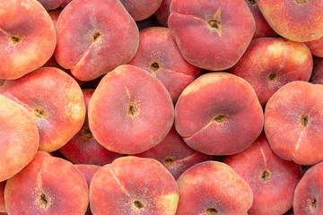Saturn peach or flat pan-tao peach closeup background with full frame captured by peaches