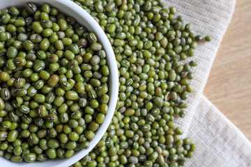 Mung bean seeds have long been used as food for human beings, green beans, seeds that are placed in a white plate, placed on a table with tears and tablecloths....