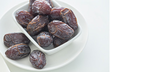 Dates palm fruit with olive in blow on white background. Food for symbolizing Ramadan.