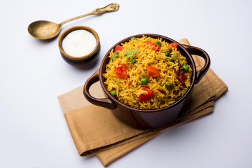 Tomato Rice also known as Tamatar Pilaf/pulav made using basmati rice, served in a bowl. selective focus