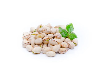Pistachio nuts with leaves.Pistachios on a white background .