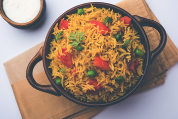Tomato Rice also known as Tamatar Pilaf/pulav made using basmati rice, served in a bowl. selective focus