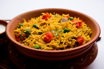 Tomato Rice also known as Tamatar Pilaf/pulav made using basmati rice, served in a bowl. selective focus