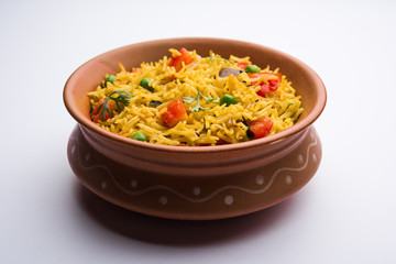 Tomato Rice also known as Tamatar Pilaf/pulav made using basmati rice, served in a bowl. selective focus