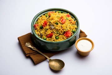 Tomato Rice also known as Tamatar Pilaf/pulav made using basmati rice, served in a bowl. selective focus