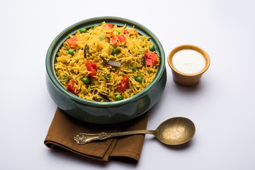 Tomato Rice also known as Tamatar Pilaf/pulav made using basmati rice, served in a bowl. selective focus