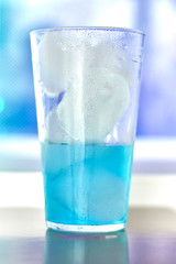 Generic blue berry syrup cocktail image. Close-up view water drops details. Cold drink for hot summer vacation holidays. Alcoholic drinks Blue Lagoon, Frostbite, Margarita, Hawaiian, Sapphire, Curacao