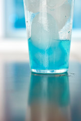 Generic blue berry syrup cocktail image. Close-up view water drops details. Cold drink for hot summer vacation holidays. Alcoholic drinks Blue Lagoon, Frostbite, Margarita, Hawaiian, Sapphire, Curacao