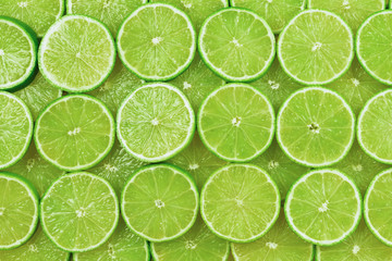 Fototapeta na wymiar Fresh lime slices as a background.