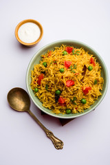 Tomato Rice also known as Tamatar Pilaf/pulav made using basmati rice, served in a bowl. selective focus