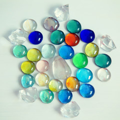 Multicolored glass round crystals on a light background.
