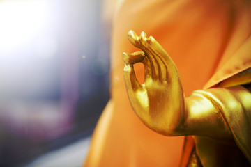Close up hand of Golden buddha statue in the temple