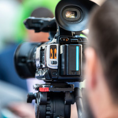 Press Conference Outdoors. Cameraman at a Media Event