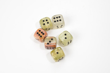 Dices made of natural stone on a white background. Copy space. Gaming.