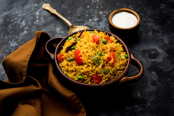 Tomato Rice also known as Tamatar Pilaf/pulav made using basmati rice, served in a bowl. selective focus