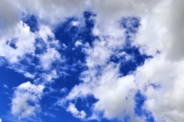 Beautiful white cumulus clouds on a deep blue sky