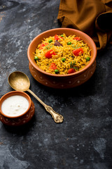 Tomato Rice also known as Tamatar Pilaf/pulav made using basmati rice, served in a bowl. selective focus