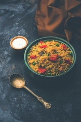 Tomato Rice also known as Tamatar Pilaf/pulav made using basmati rice, served in a bowl. selective focus