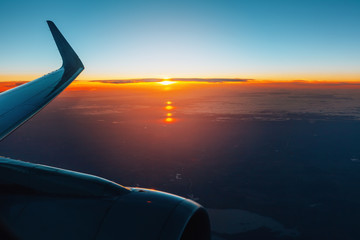 Naklejka na ściany i meble Aerial view from airplane window at sunset.