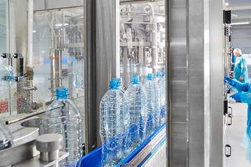 A closeup of a robotic mineral water production line