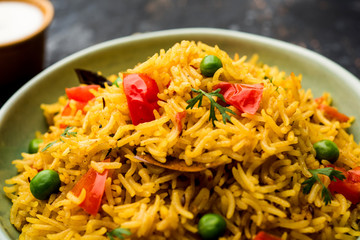 Tomato Rice also known as Tamatar Pilaf/pulav made using basmati rice, served in a bowl. selective focus
