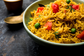 Tomato Rice also known as Tamatar Pilaf/pulav made using basmati rice, served in a bowl. selective focus