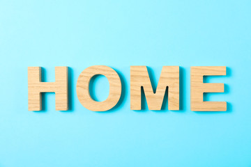 Word House lined with wooden letters on color background, top view