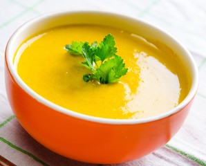 Carrot soup served on the table in bowl