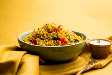 Tomato Rice also known as Tamatar Pilaf/pulav made using basmati rice, served in a bowl. selective focus