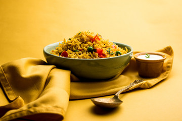 Tomato Rice also known as Tamatar Pilaf/pulav made using basmati rice, served in a bowl. selective focus