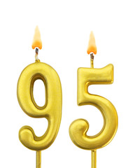 Burning golden birthday candles isolated on white background, number 95