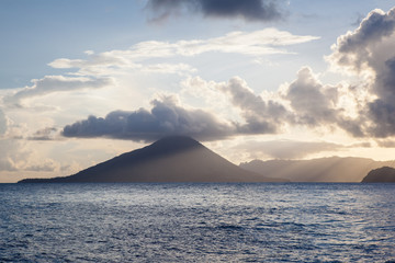 The majestic volcano of Gunung Api rises from the seascape in the Banda Islands of Indonesia. This region is also known as the Spice Islands where the worldwide spice trade was once centered.