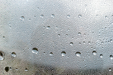 Natural water drops on glass