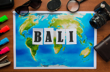 Naklejka premium Bali word letters inscription wooden table top view. Preparation for the journey vacation travel concept