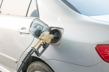Yellow nozzle Refueling into the tank at the gas station, transportation energy, technology concept, energy business, transportation
