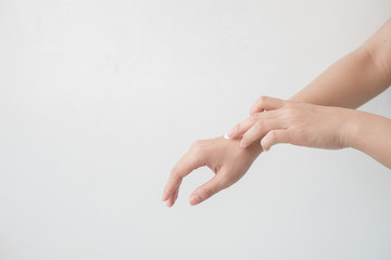 Closeup of beautiful female hands holding hands and applying a moisturizer. Beauty woman's hand applying cream.