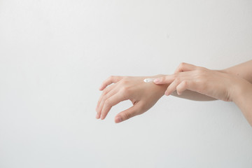 Closeup of beautiful female hands holding hands and applying a moisturizer. Beauty woman's hand applying cream.