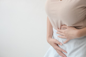 Women with abdominal pain standing, holding the body and hands Photos, concepts of health and medical care