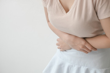Women with abdominal pain standing, holding the body and hands Photos, concepts of health and medical care