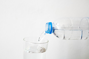 Pouring drinking water in a glass White background