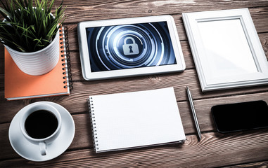 Web security and technology concept with tablet pc on wooden table