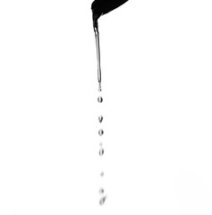 water pouring from a bottle into glass isolated on white