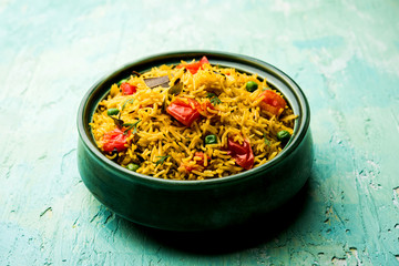 Tomato  pulav/Pilaf made using basmati rice, served in a bowl. selective focus