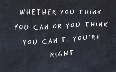 Black chalkboard with handwritten wise motivational quote 