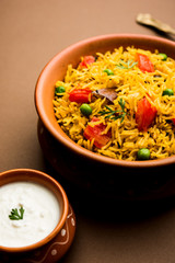 Tomato  pulav/Pilaf made using basmati rice, served in a bowl. selective focus